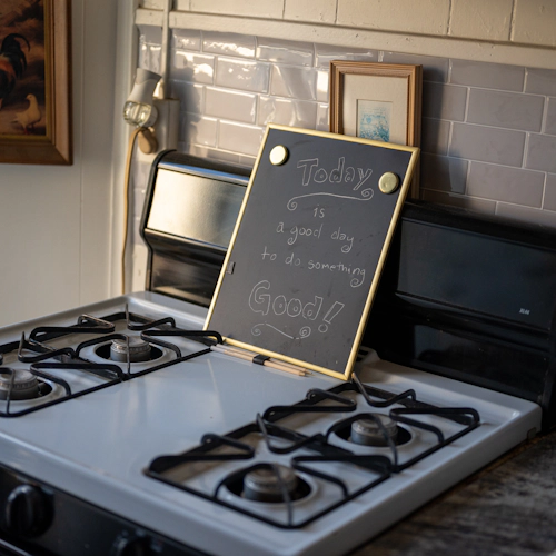 An on-site stove with a friendly reminder, 'Today is a good day to do something good!'